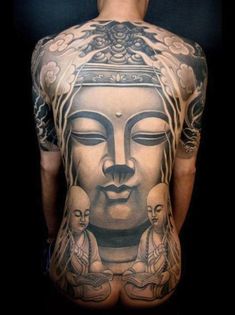 the back of a man with tattoos on his body and head in buddha pose,