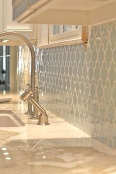 a kitchen counter top with a sink and faucet in the middle of it