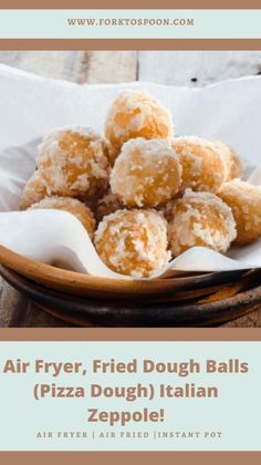 a bowl filled with fried dough balls sitting on top of a table