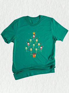 Introducing our Wine Tree Shirt!  Get ready to spread some holiday cheer with this Funny Drinking Shirt that is perfect for the most wonderful time of the year! ✨ Celebrate a Happy Christmas and stand out at any Christmas Party with this fun and festive Christmas Tee.  Whether you're mingling with friends or enjoying quality family time, this Believe Shirt is sure to bring a smile to everyone's face.  Made with love and attention to detail, this Wine Tree Shirt is more than just a Christmas Gift - it's a statement piece that showcases your love for both wine and the holiday season. ❤️ Featuring an adorable Santa and a beautifully decorated Christmas Tree, this holiday shirt effortlessly combines tradition with a touch of humor.  The playful design is the perfect conversation starter and wi Wine Christmas Shirts, Christmas Wine Shirt, Wine Tree, Funny Drinking Shirts, New Years Shirts, Wine Shirts, Christmas Pjs, Santa Shirts, Drinking Humor