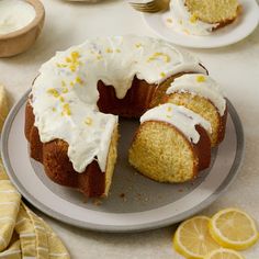 a lemon bunt cake on a plate with one slice cut out