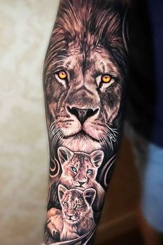 a lion and her cub tattoo on the left arm, with orange eyes behind it