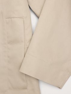 Often called a "Mac Coat", this relaxed iteration of a tailored rain coat is cut from a bonded cotton fabric finished with a water-resistant coating and fully sealed seams to keep the elements at bay.  Water-Repellant Relaxed fit.  Warmer: Unlined.  Point collar with snap front closure.  Two front pockets.  Center-back box pleat detail.  Unlined.  Relaxed fit with A-line skirt.  Long sleeves.  Midi length.  Model: Size S, 5'10" (178cm). Modern Raincoat With Pockets For Spring, Long Sleeve Cotton Raincoat For Work, Classic Cotton Outerwear With Straight Hem, Cotton Raincoat For Workwear In Fall, Fall Cotton Raincoat For Workwear, Fall Cotton Raincoat For Work, Gabardine Workwear Raincoat With Pockets, Workwear Raincoat With Pockets, Classic Solid Raincoat With Pockets