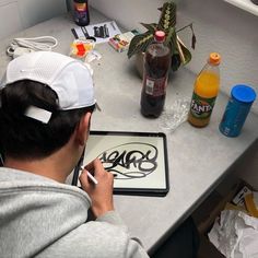 a person sitting at a table with some food and drinks on it's desk