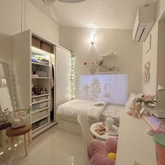 a bedroom with a bed, desk and chair in it's center area next to a closet