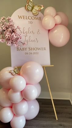 a welcome sign and balloons for a baby shower