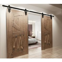 two wooden doors open to reveal a bedroom