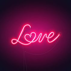 a neon sign with the word love written in cursive writing, on a dark background