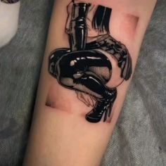 a woman's arm with a tattoo on it that has an image of a boot and boots