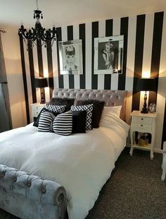 a bedroom with black and white striped walls