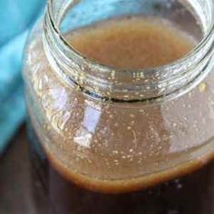 a glass jar filled with liquid sitting on top of a table