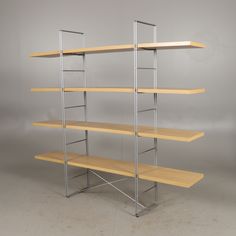 a wooden shelf with metal brackets and shelves on each side, against a gray background