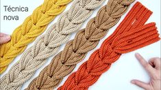 there are four different colors of braids on the white table and one is orange, yellow, brown, and tan