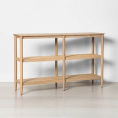 a wooden shelf sitting on top of a white floor