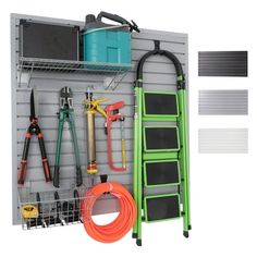 a garage storage rack with tools and hoses hanging from it's side wall