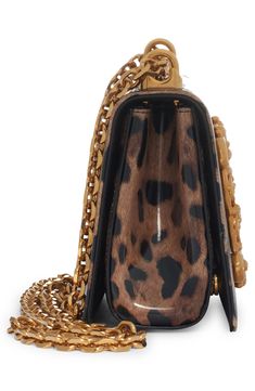 A baroque-inspired D&G logo adds to the glamour of this leopard-print leather bag featuring a pull-through strap that allows for crossbody or shoulder wear. Magnetic-snap flap closure Pull-through chain strap Leather lining Leather Made in Italy Designer Handbags Evening Shoulder Bag In Leopard Print With Detachable Strap, Leopard Print Shoulder Bag With Detachable Strap For Evening, Evening Leopard Print Shoulder Bag With Detachable Strap, Elegant Evening Shoulder Bag In Leopard Print, Elegant Leopard Print Shoulder Bag With Detachable Handle, Luxury Leopard Print Bags For Formal Events, Evening Bags With Detachable Strap In Leopard Print, Evening Bags With Leopard Print And Detachable Strap, Luxury Leopard Print Shoulder Bag With Gold-tone Hardware