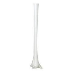 a tall white vase sitting on top of a table