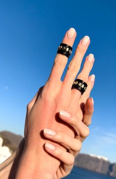 "A stylish black leather 2 ring set with silver studs, that is totally out of the ordinary. The set includes two leather rings. The first is a \"regular\" ring and the second is an above the knuckle ring. Both rings are adjustable in size and they can be stacked up any way you like. You can wear them in countless ways. Effortlessly stylish and simple, this set of rings will add loads of character to your everyday looks. A lovely piece, that is easy to wear and always leaves an impression. Also a Adjustable Black Punk Style Rings, Punk Leather Jewelry With Black Band, Punk Style Adjustable Black Ring, Punk Style Leather Jewelry With Black Band, Adjustable Black Studs Jewelry, Black Leather Jewelry With Studs, Punk Leather Jewelry With Rivets, Adjustable Black Rings For Everyday Wear, Edgy Leather Jewelry With Black Band