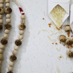 some food is laying out on the table next to it's string and beads