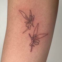 two small hummingbirds on the back of a woman's thigh