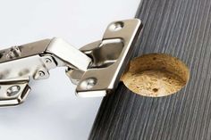 a close up of a door hinge with a cork in the middle and an opening on the side