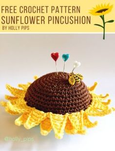 a crocheted sunflower pincushion with two pins on it and the words free crochet pattern by holly pipps