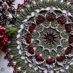 a crocheted doily surrounded by christmas decorations