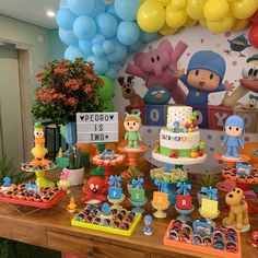 an image of a birthday party with balloons and toys on the table in front of it