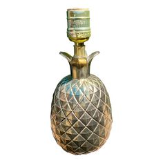 a gold pineapple shaped glass bottle is shown