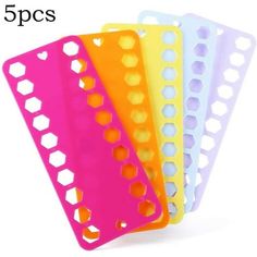 five pieces of plastic cutting board with holes on each side and four different colors in the middle