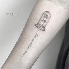 a tattoo on the arm of a person with a flower in a glass jar that says,