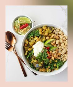 a white bowl filled with rice, beans and greens next to a spoon on a table