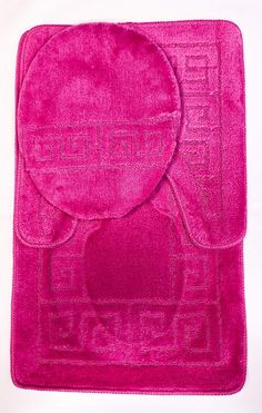 a pink bath mat with an elephant design on the front and back side, sitting on top of a white surface