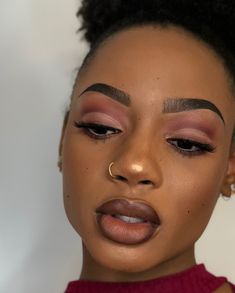 a close up of a woman with makeup on her face and hair in an afro hairstyle