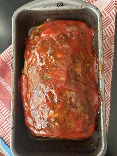 the meatloaf is covered in sauce and ready to be cooked on the grill