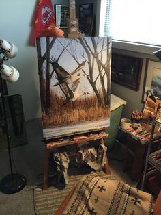 an easel with a painting on it in a room