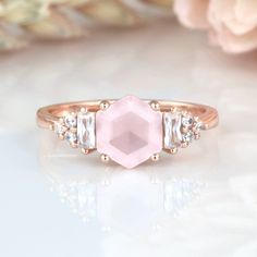 Gorgeous Hexagon Natural Rose Quartz Ring ►Base Metal: Sterling Silver (925) ►Plating: 14K Rose Gold ►Average band width: 1.7 mm. Center Stone: Rose Quartz Color: Pink Gemstone creation: Natural Shape: Hexagon Measurements: 7.0 mm Carat Weight: 1.2 ct. (approx.) Hardness (Mohs hardness scale): 7 Luster: Vitreous ►Healing properties: Lowering stress and tension in the heart, Rose Quartz clears out anger, jealousy, and resentment of others, and allows healing of heart issues and dis-ease associate Rose Quartz Color, Unique Promise Rings, Gemstone Engagement Ring, Quartz Engagement Ring, Engagement Ring For Women, Rose Quartz Ring, Gemstone Engagement, Solid Gold Jewelry, Pink Gemstones