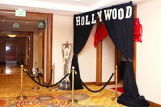 an entrance to a hollywood themed event with black and red drapes