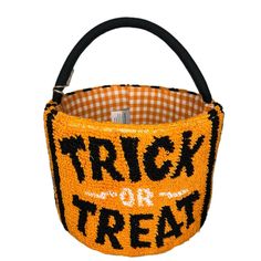 a trick or treat basket with the words trick or treat in black and orange on it