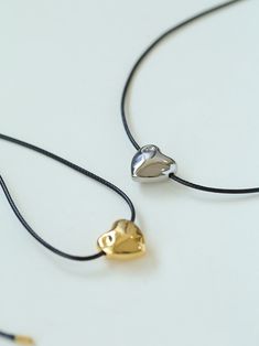 Elevate your style with our charming heart shaped black drawstring pendant necklace. Featuring a sleek black drawstring chain adorned with a heart shaped pendant, this elegant necklace exudes timeless sophistication. The simple design easily pairs with any outfit. Well-made with great attention to detail, this necklace is a must-have addition to your jewelry collection. Metal: 18K Recycled Gold Plated On Brass/Recycled Sterling Silver Plated On Brass Chain Length: 750mm Pendant Length: 17mm Weig Slider Necklace, Edison Pearls, Heart Shaped Pendant, Elegant Necklace, Charm Pendant Necklace, Heart Shape Pendant, Tiger Eye Stone, Elegant Necklaces, Recycled Gold