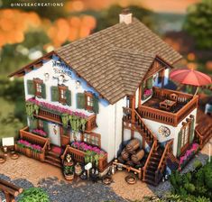 a small house with flowers and plants on the balcony is shown in an animated scene