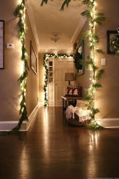 the hallway is decorated for christmas with garlands and lights