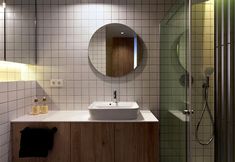 a white sink sitting under a bathroom mirror