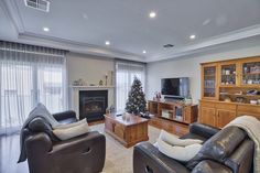 a living room filled with furniture and a christmas tree