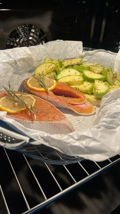 salmon and cucumbers are on the tray in the oven