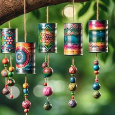 colorful tin can ornaments hanging from a tree branch