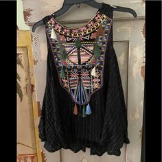 Black Full Fitting Top Has Gold Thread Design Wt Colors Of Stitching Very Pretty Excellent Condition Black Sleeveless Bohemian Blouse, Bohemian Black Sleeveless Blouse, Bohemian Sleeveless Black Blouse, Embroidered Black Blouse For Beach, Embroidered Black Beach Blouse, Black Embroidered Festival Tops, Black Fitted Bohemian Tops, Black Sleeveless Bohemian Top, Fitted Black Bohemian Tops