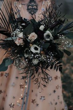 a woman holding a bouquet of flowers in her hands