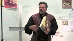 a man standing in front of a whiteboard holding a book