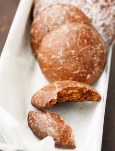 some kind of bread that is on a white tray with other food items in the background